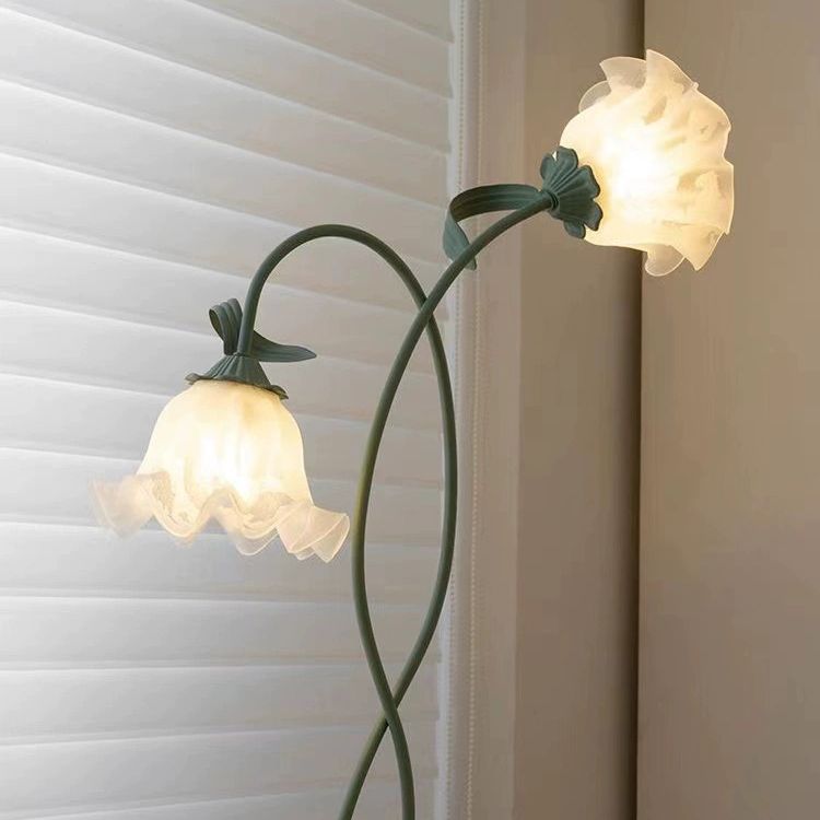 Close-up view of the green floor lamp with white glass shades