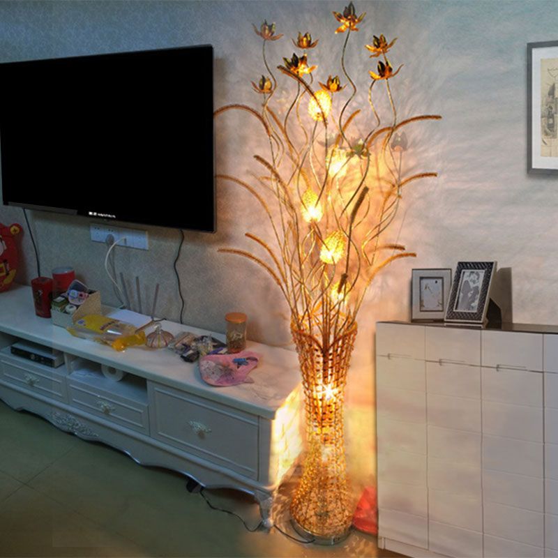 Elegant gold blossom metal LED floor lamp in a cozy living room setting.