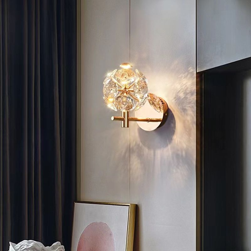 Gold crystal wall sconce showcasing ambient light in a living room setting.
