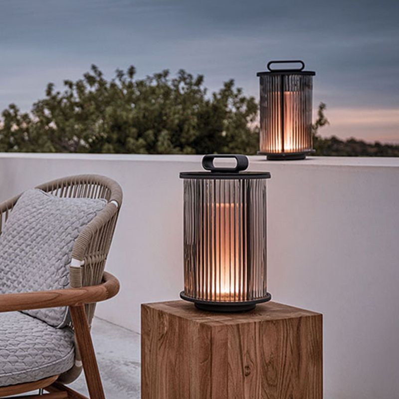 Front view of solar post light showing ribbed glass and warm glow