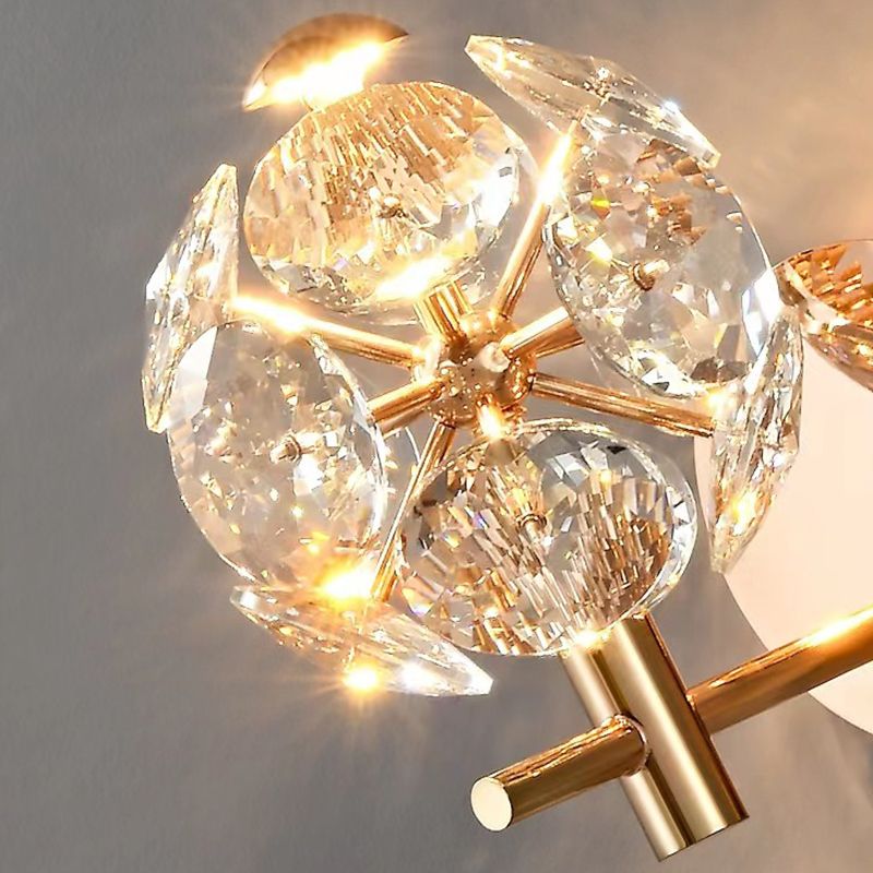 Gold crystal wall sconce showcasing ambient light in a living room setting.
