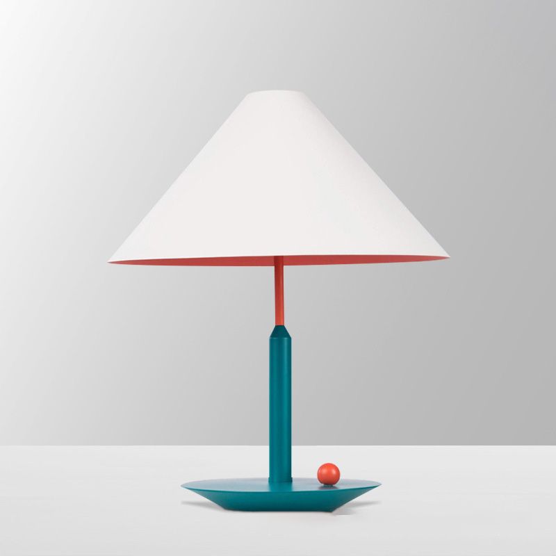 Top rated cone shape lamp for study illuminating a desk with a warm ambiance.