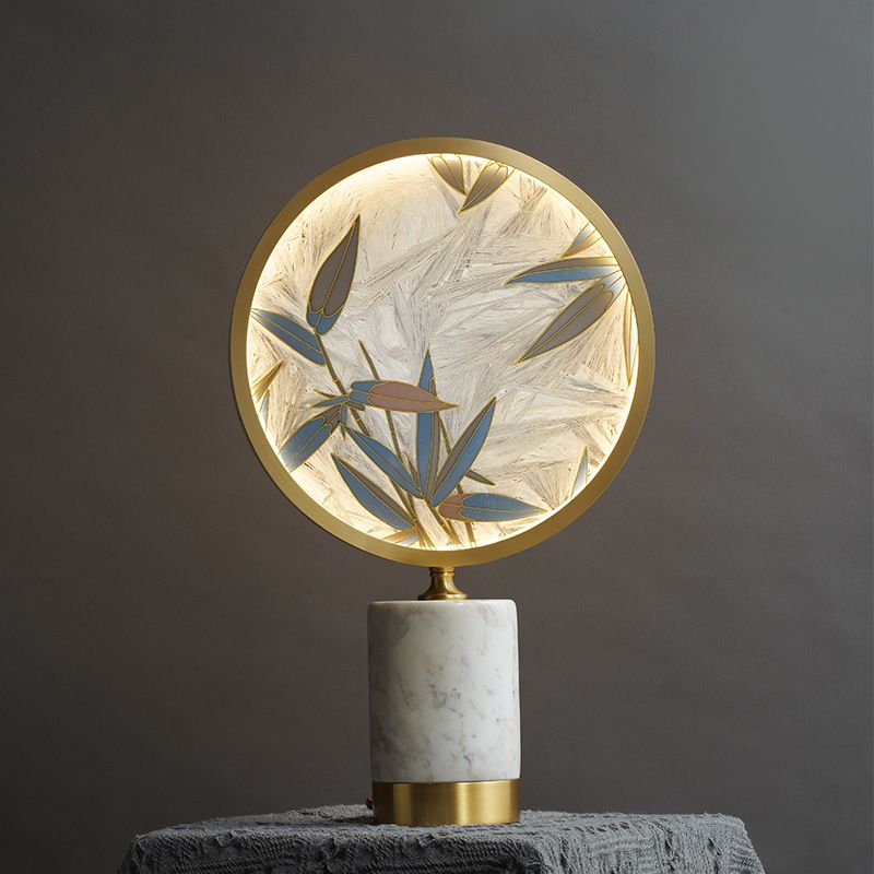 Close-up view of the modern lamps intricate bamboo leaf design and light shade.