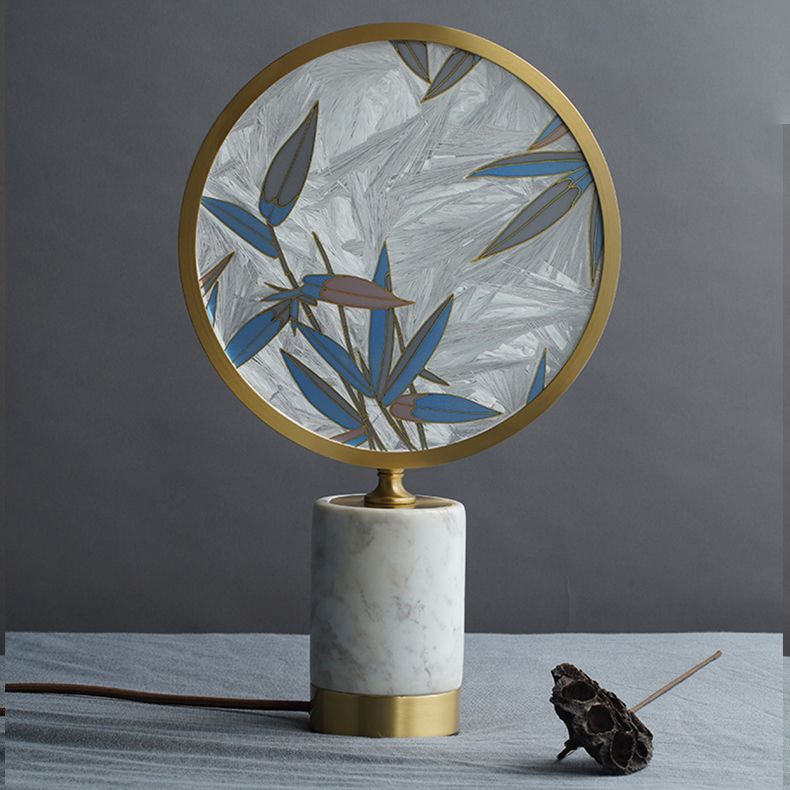 Elegant bamboo leaf table lamp showcasing its glazed enamel detail and marble base from a side angle.