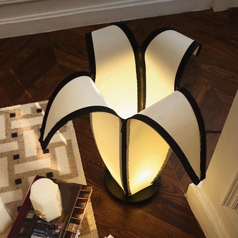 Side angle of banana shape table lamp illuminating a boys room.