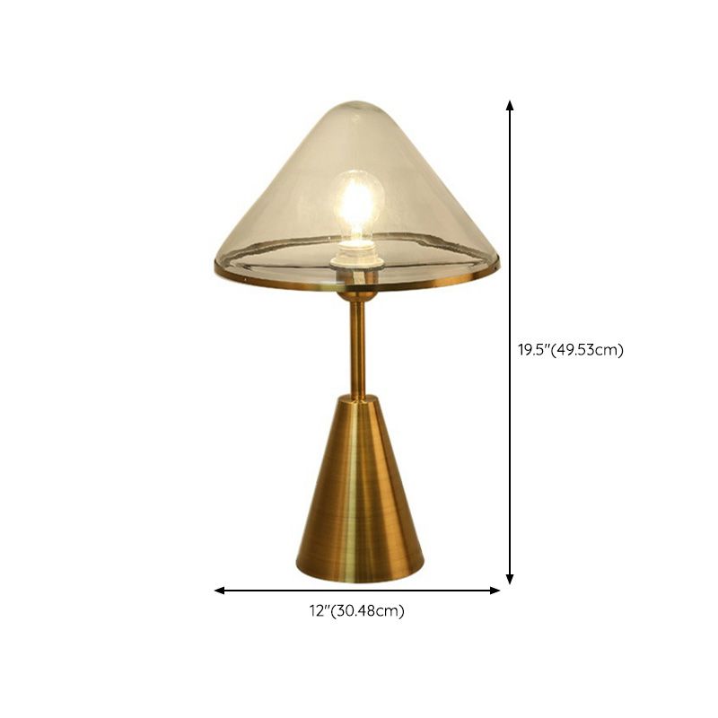 Close-up of the glass shade of the gold wrought iron lamp, highlighting its design and craftsmanship.