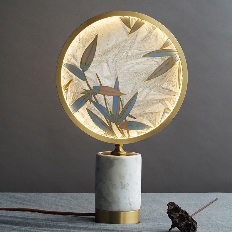 The elegant bamboo lamp illuminated in a cozy bedroom setting, highlighting its stylish design.