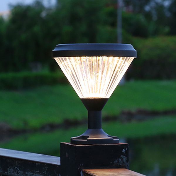 Close-up of the polycarbonate lampshade of the outdoor post light under rainy conditions