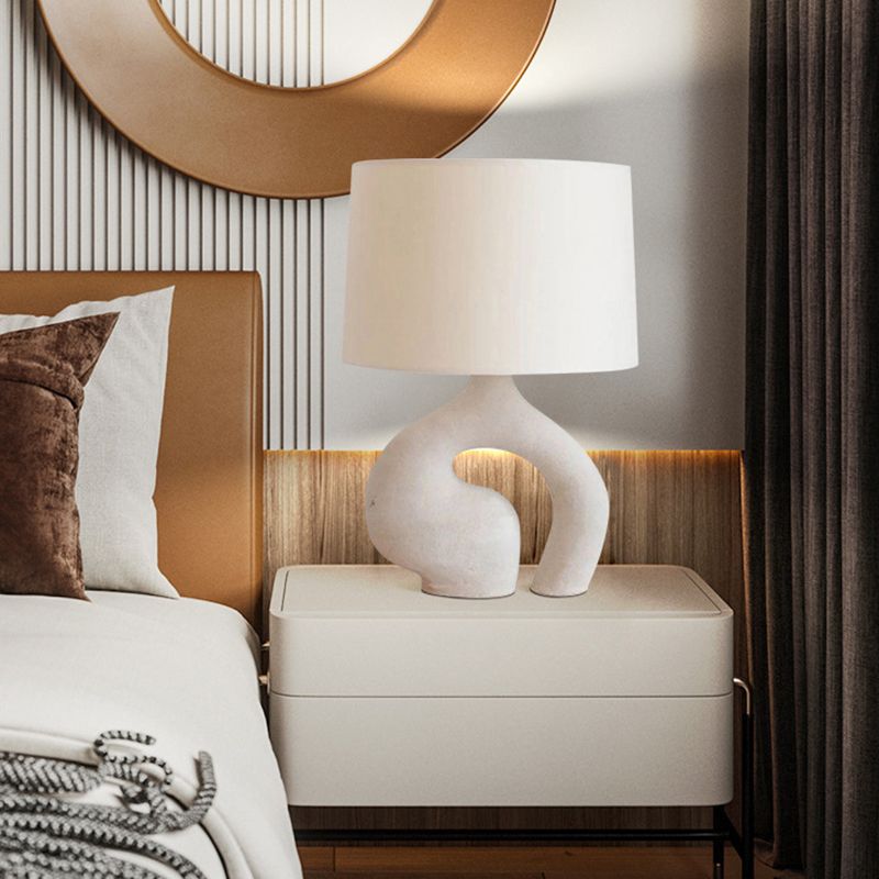 Close-up of the elegant white resin lamp, highlighting its chic details.