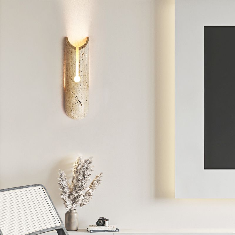 Stylish beige wall sconce illuminating a living room with warm light