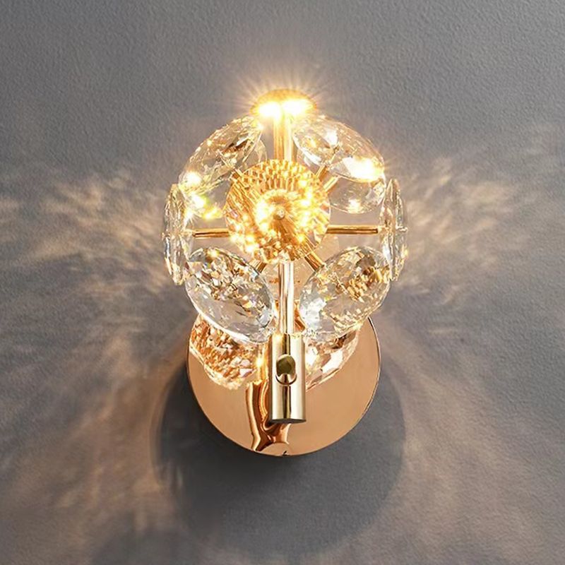 Gold crystal wall sconce showcasing ambient light in a living room setting.