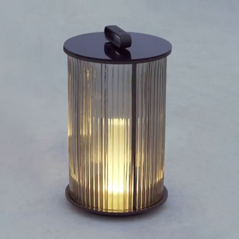 Front view of solar post light showing ribbed glass and warm glow