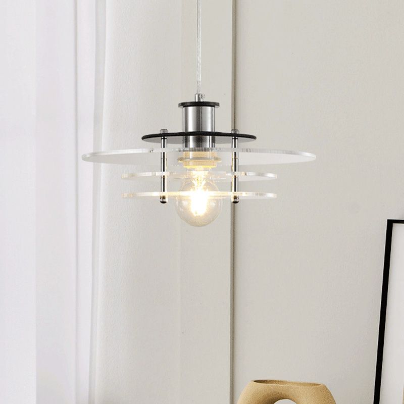 Side view of the LucentForm acrylic pendant light hanging above a minimalist dining table