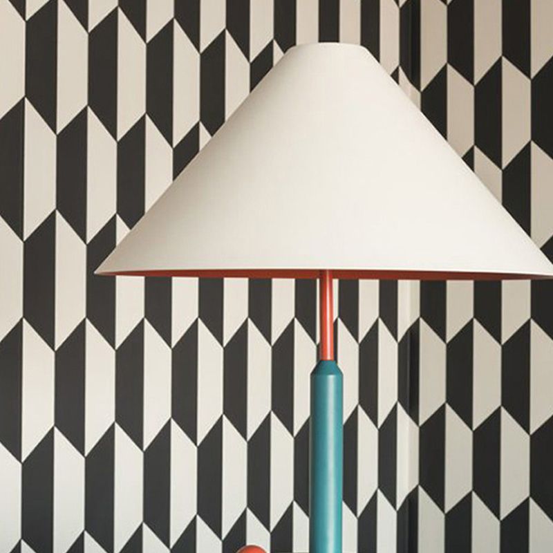 Elegant modern cone table lamp showcasing its stylish fabric shade in a cozy living room setting.