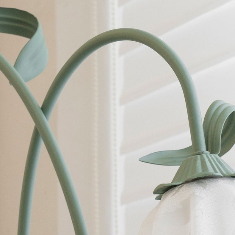 Green linear floor lamp positioned next to a modern sofa