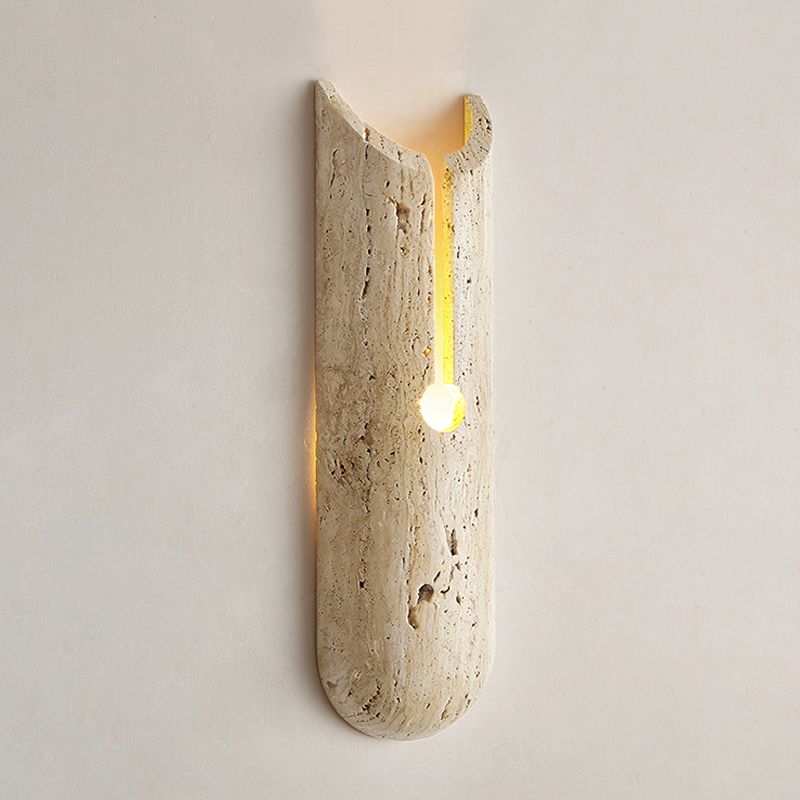 Stylish beige wall sconce illuminating a living room with warm light