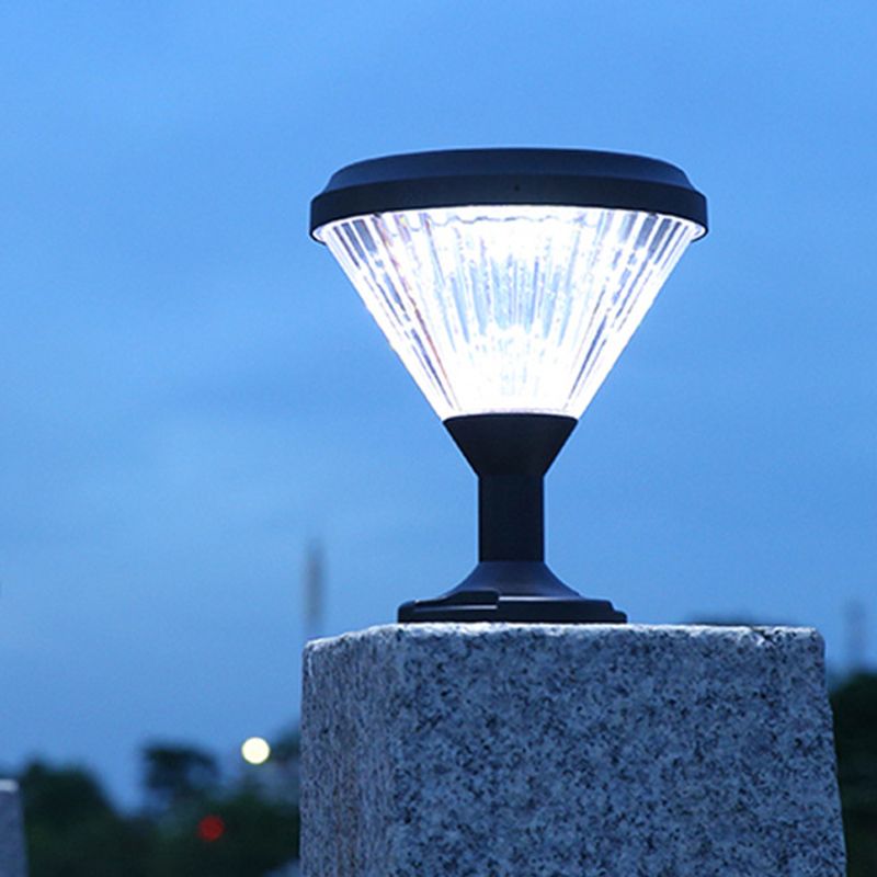 Close-up of the polycarbonate lampshade of the outdoor post light under rainy conditions
