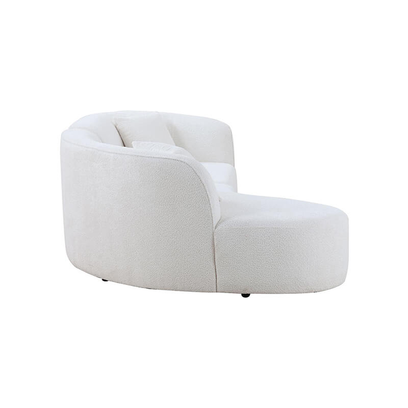 Close-up of the plush foam padding on the modern curved sofa.