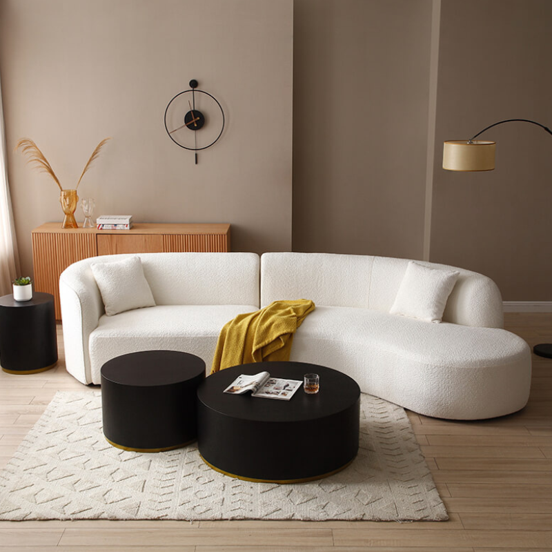 View of the elegant white curved sectional sofa from the side, showcasing its plush cushions and sleek design.