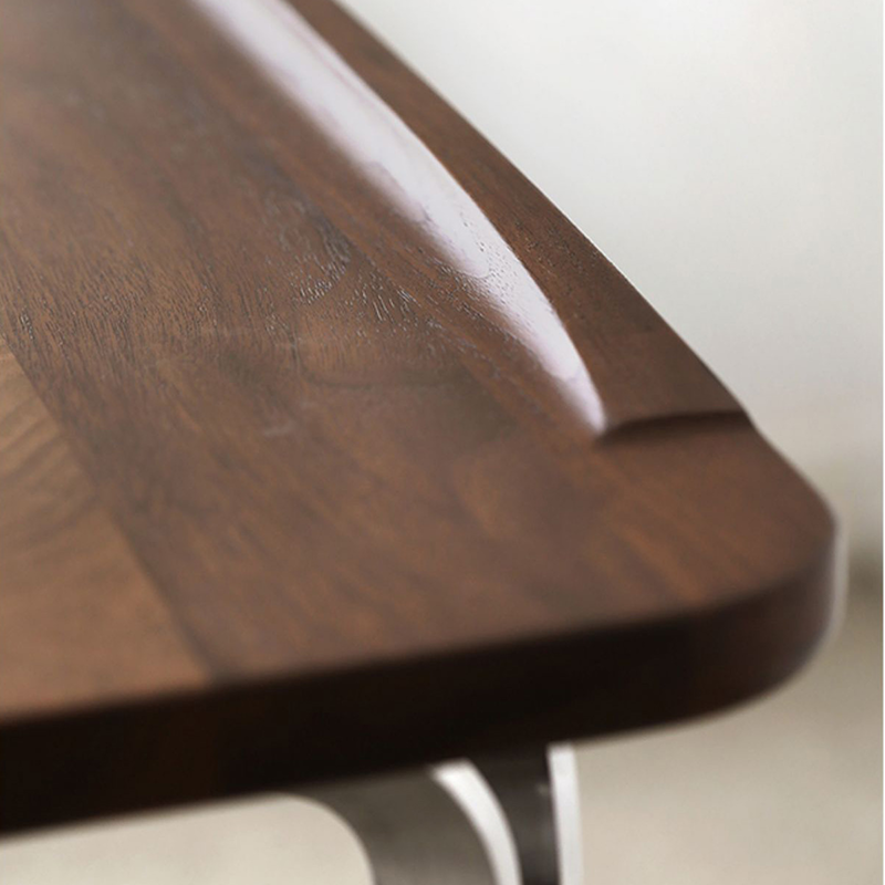 Front view of modern black walnut desk with steel legs, showcasing its elegant design.