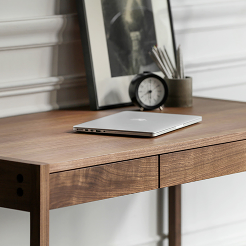 Front view of the modern walnut writing desk showing its sleek design and hidden storage.