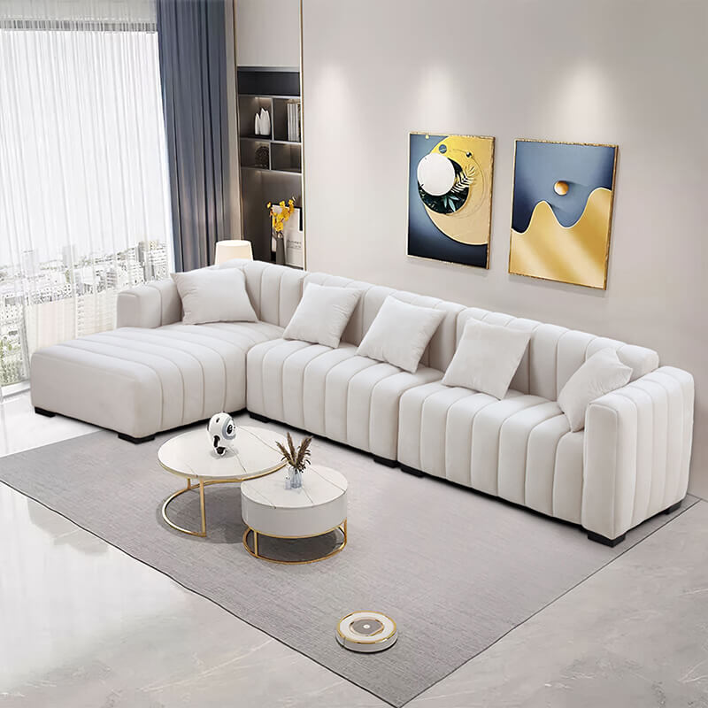 Side view of the elegant beige L-shaped sectional sofa showcasing its tufted design.