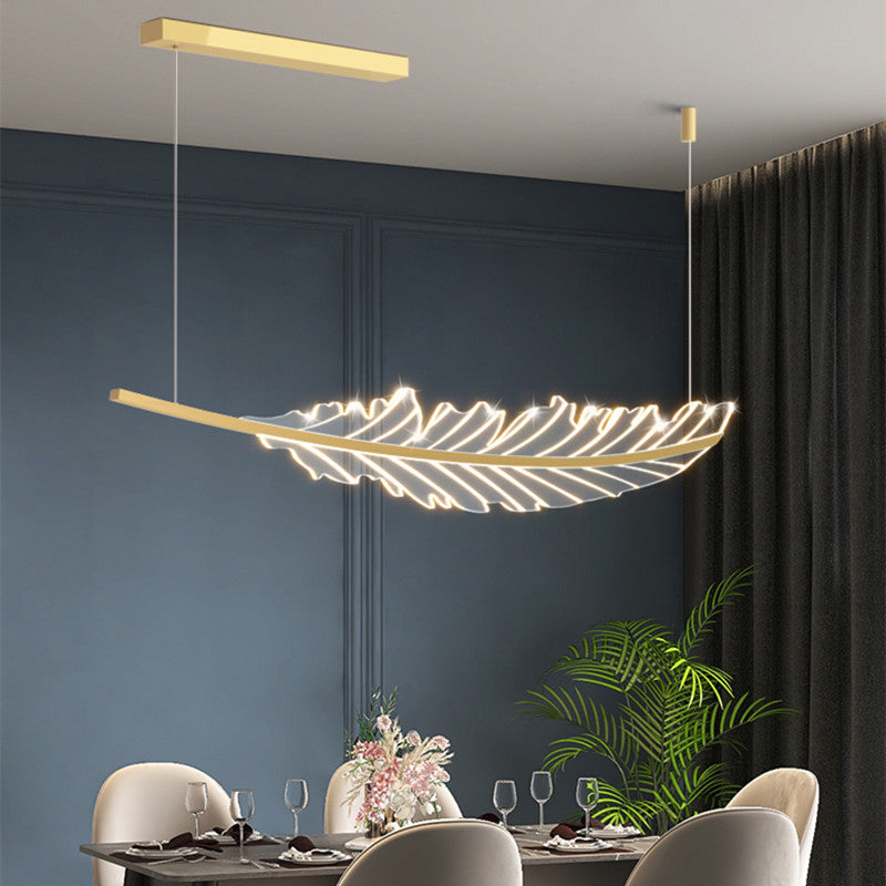 Elegant gold leaf pendant light hanging above a kitchen island, showcasing its unique design.