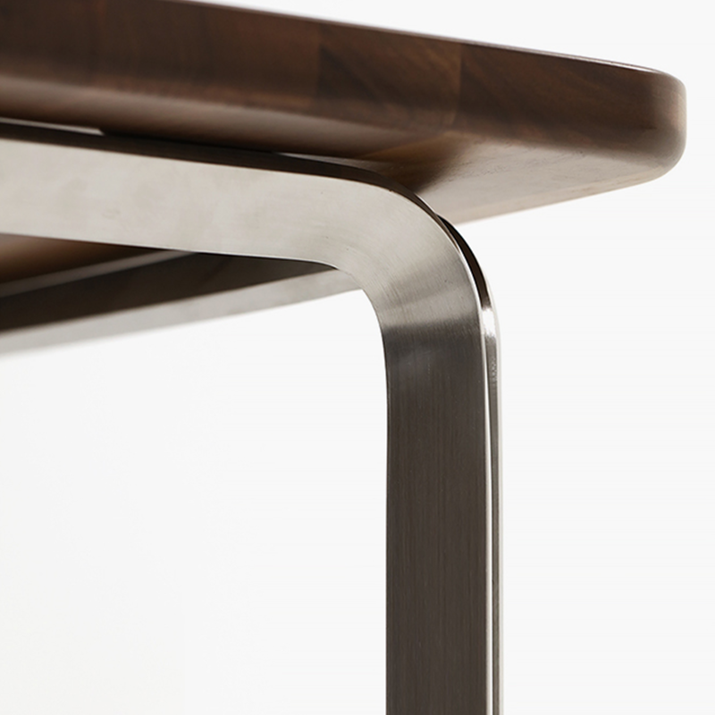 Side angle of the black walnut desk, highlighting the sturdy steel frame and spacious surface.