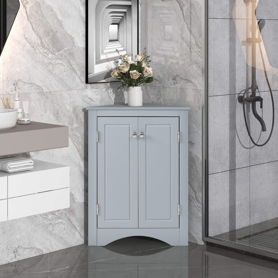 Modern blue corner cabinet showcasing adjustable shelves in a small bathroom setting.