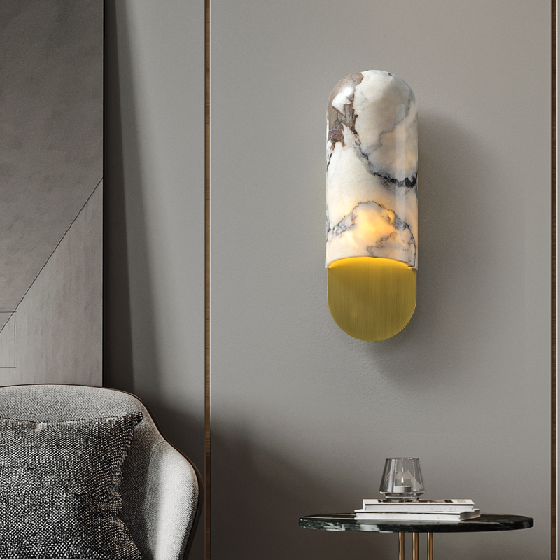 Close-up of the marble texture and copper finish on the wall sconce.