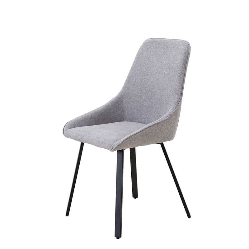 Set of four gray upholstered chairs arranged around a dining table, highlighting their modern style.
