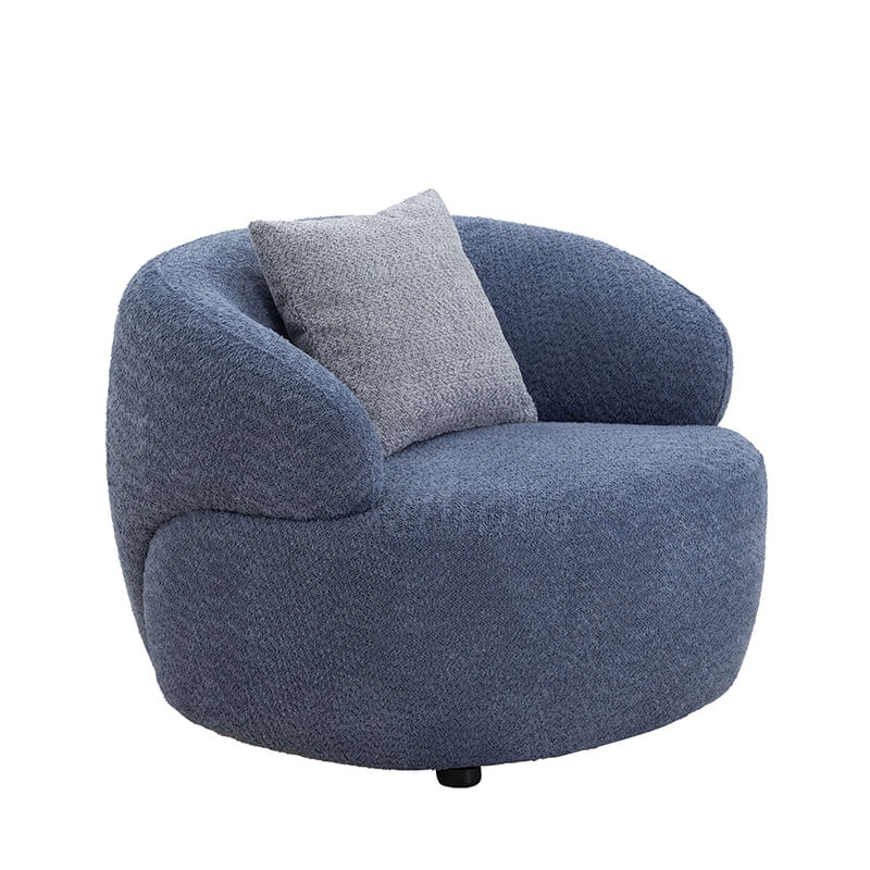Cozy living room setup featuring the blue mid-century curved swivel sofa with decorative cushions.