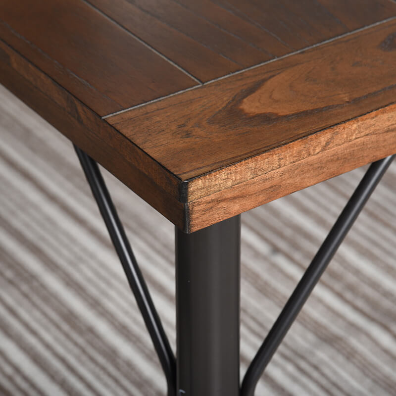 Angle view of rustic brown poplar wood dining table with black metal legs, showcasing its stylish design.