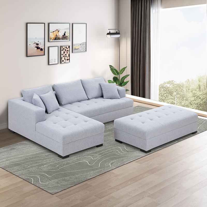 Light grey tufted sectional sofa in a contemporary living room setting