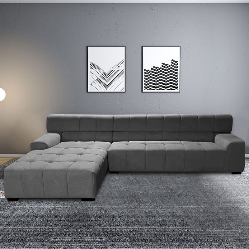 Chic dark grey fabric sectional sofa in a modern living room setting, showcasing its spacious design and soft cushions.