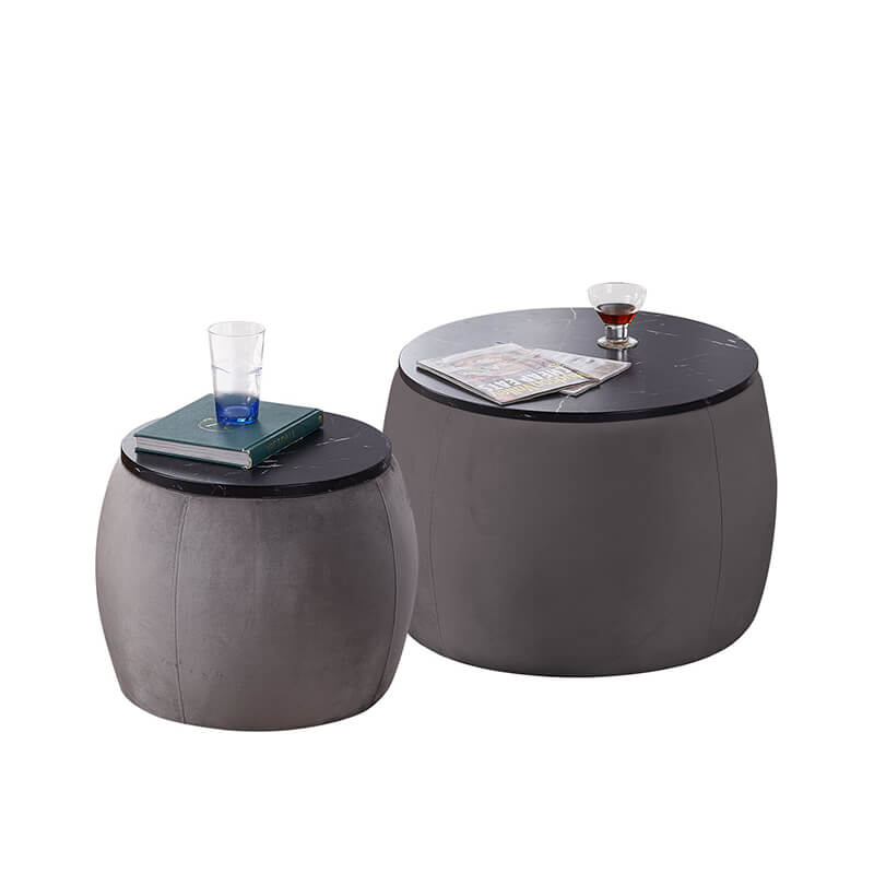 Versatile use of the grey storage ottoman as a coffee table in a cozy living room setting, surrounded by decorative items.