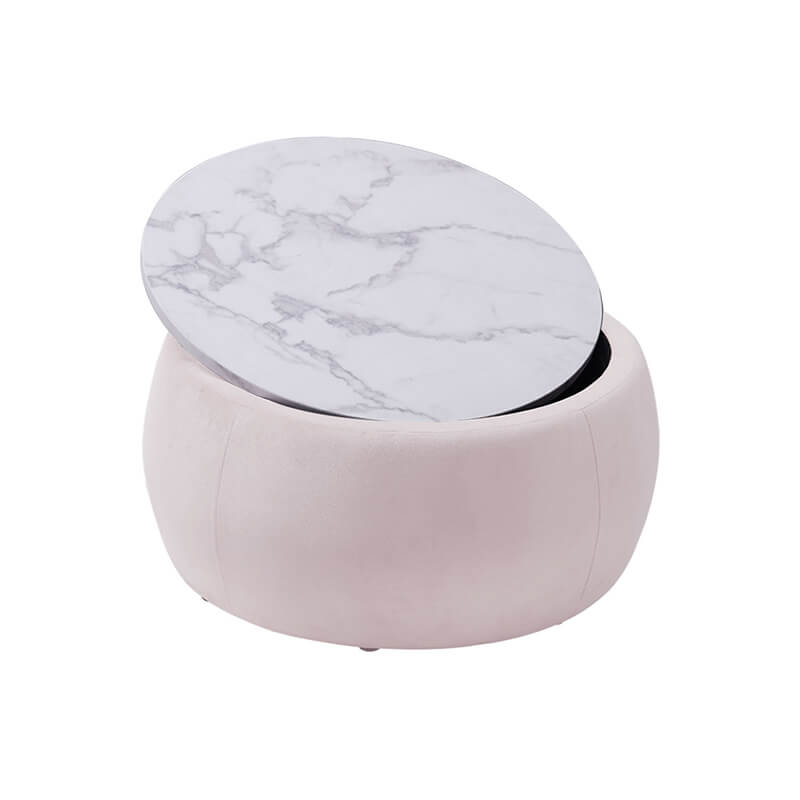 Lifestyle shot of the pink ottoman in a cozy living room setting, used as a footstool.