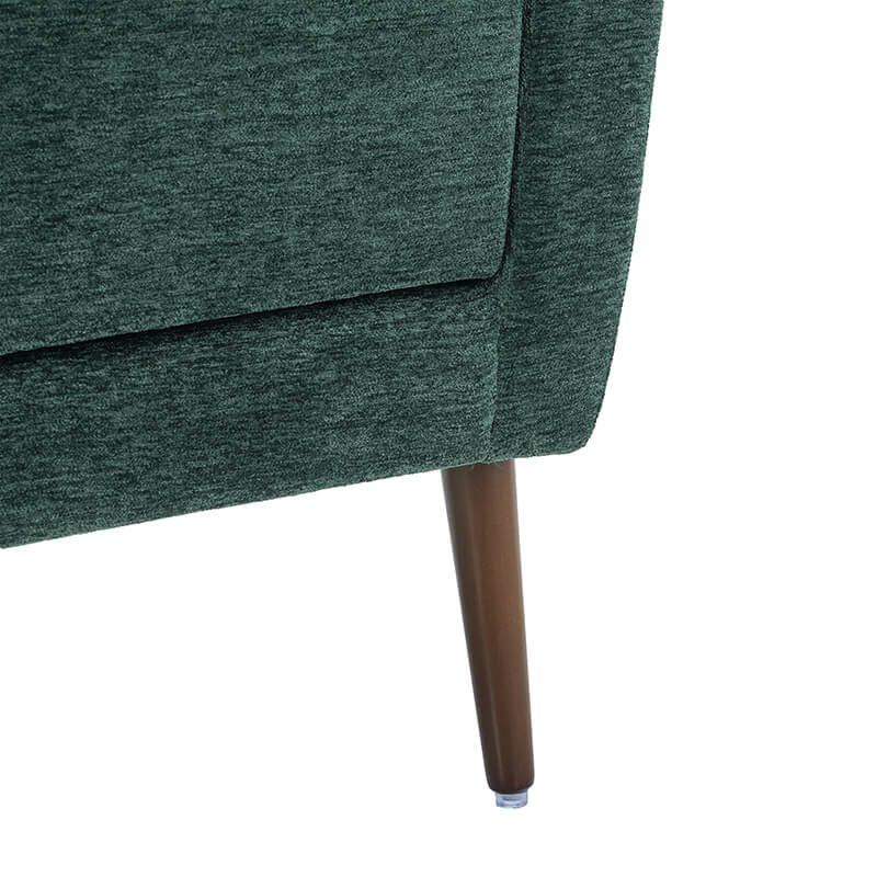 Side angle of the modern green accent chair highlighting the elegant oak legs.