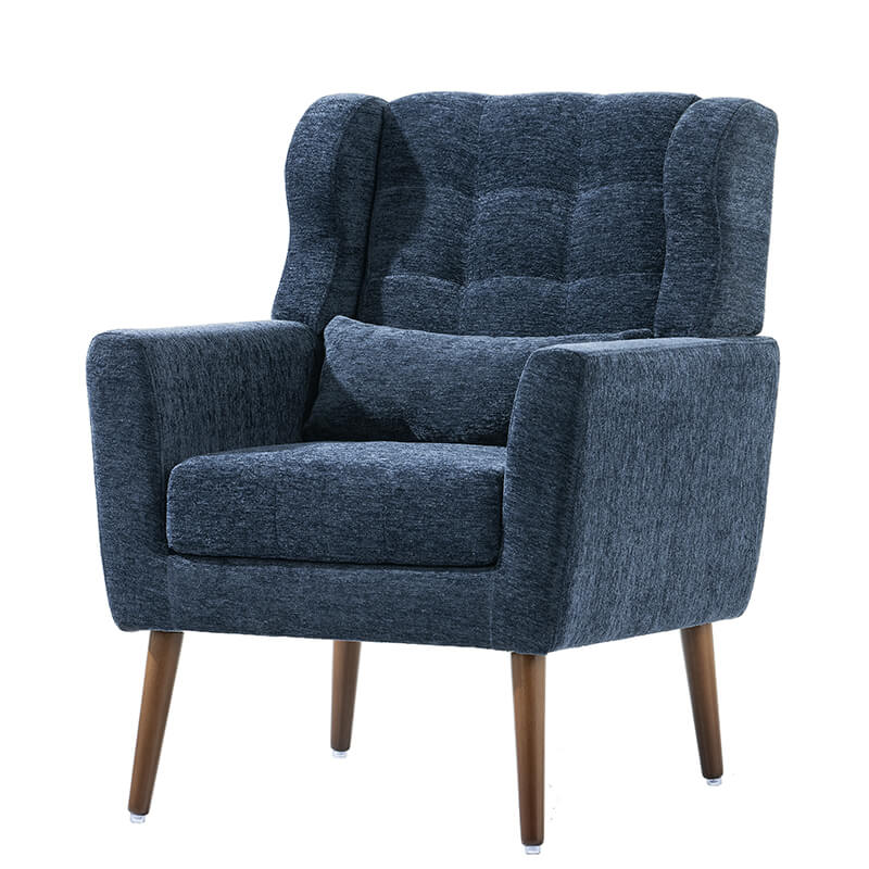 Comfortable dark blue upholstered chair used for reading in a cozy corner.