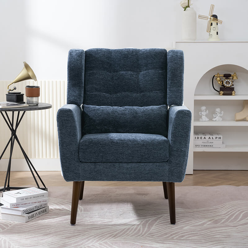 Dark blue upholstered accent chair in a stylish living room setting.