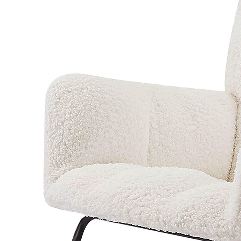 View of the beige upholstered rocking chair with high backrest in a bright nursery setting.