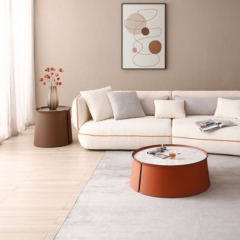 Elegant saddle leather coffee table with brown marble top, showcasing the round shape and luxurious finish.