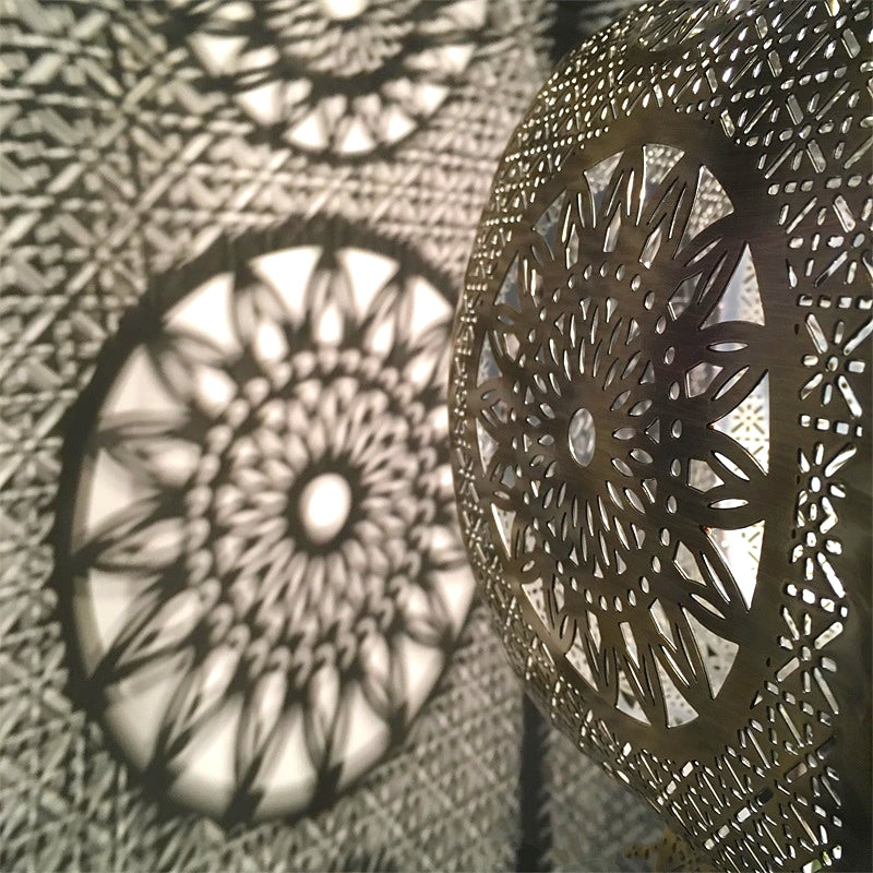 Moroccan vintage pendant light hanging in a dining room, showcasing its intricate designs.