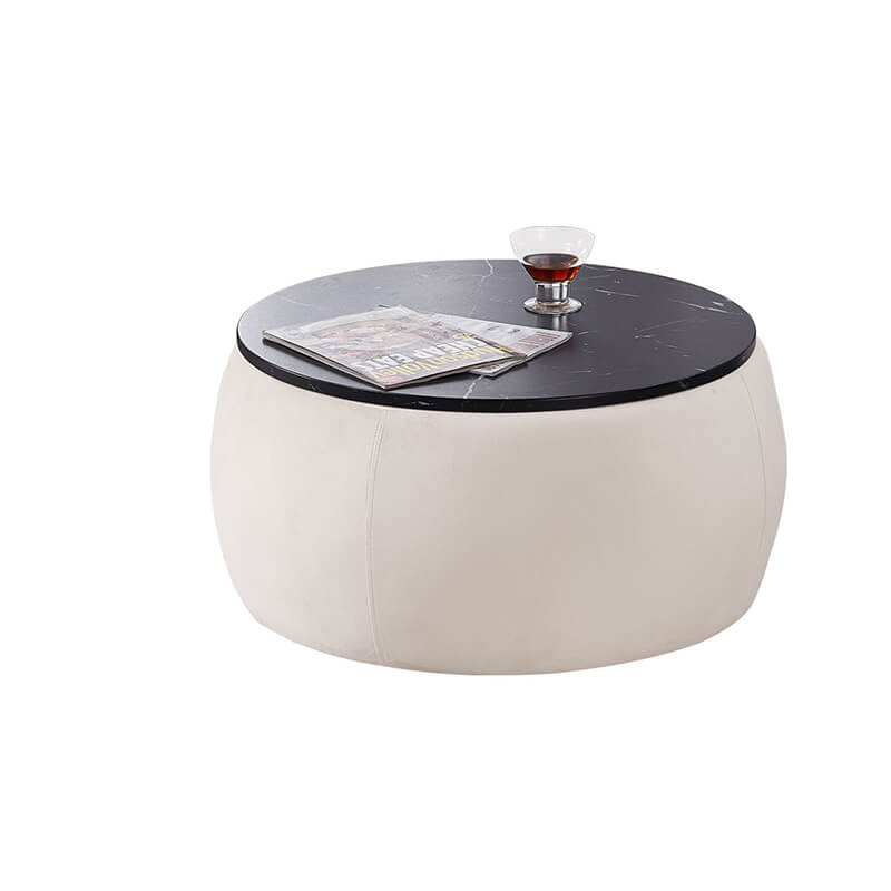 Elegant beige round ottoman used as a footstool in a modern living room.