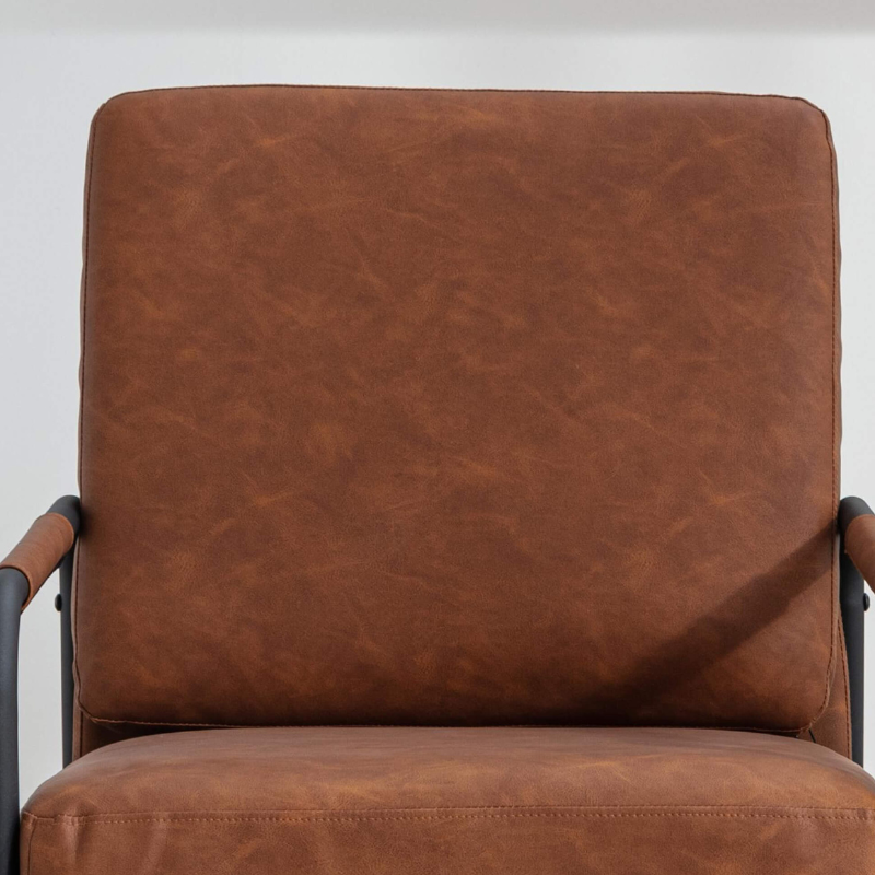Stylish leather armchair with metal legs in a modern living room