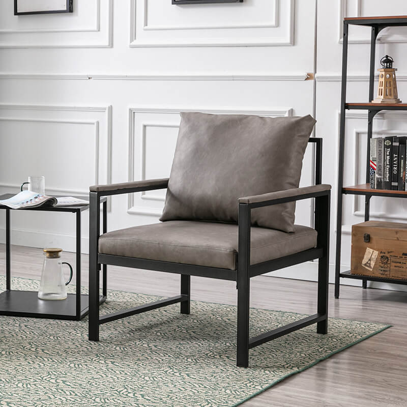 Side view of the sophisticated gray PU leather accent chair highlighting its padded back and black metal frame.