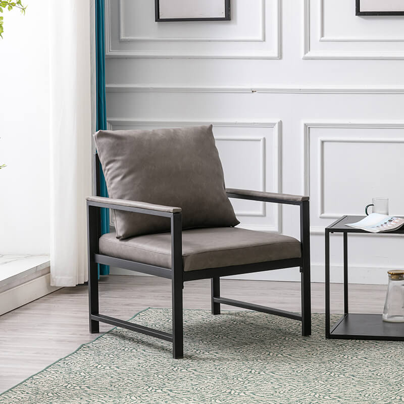 Lifestyle shot of the modern gray PU leather accent chair in a stylish living room setting.