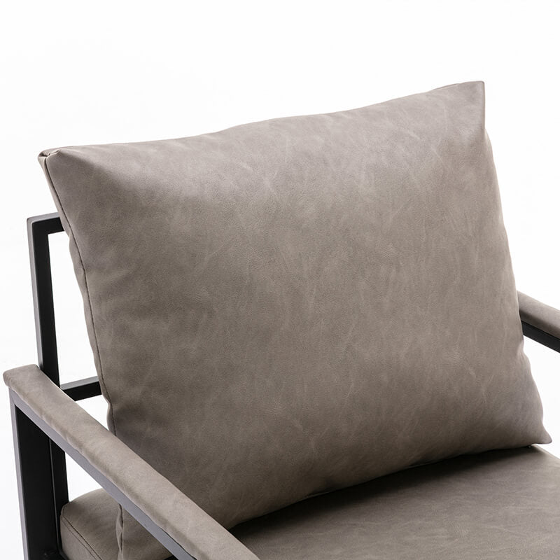 Close-up of the PU leather upholstery and padded back of the gray accent chair, showcasing its luxurious comfort.