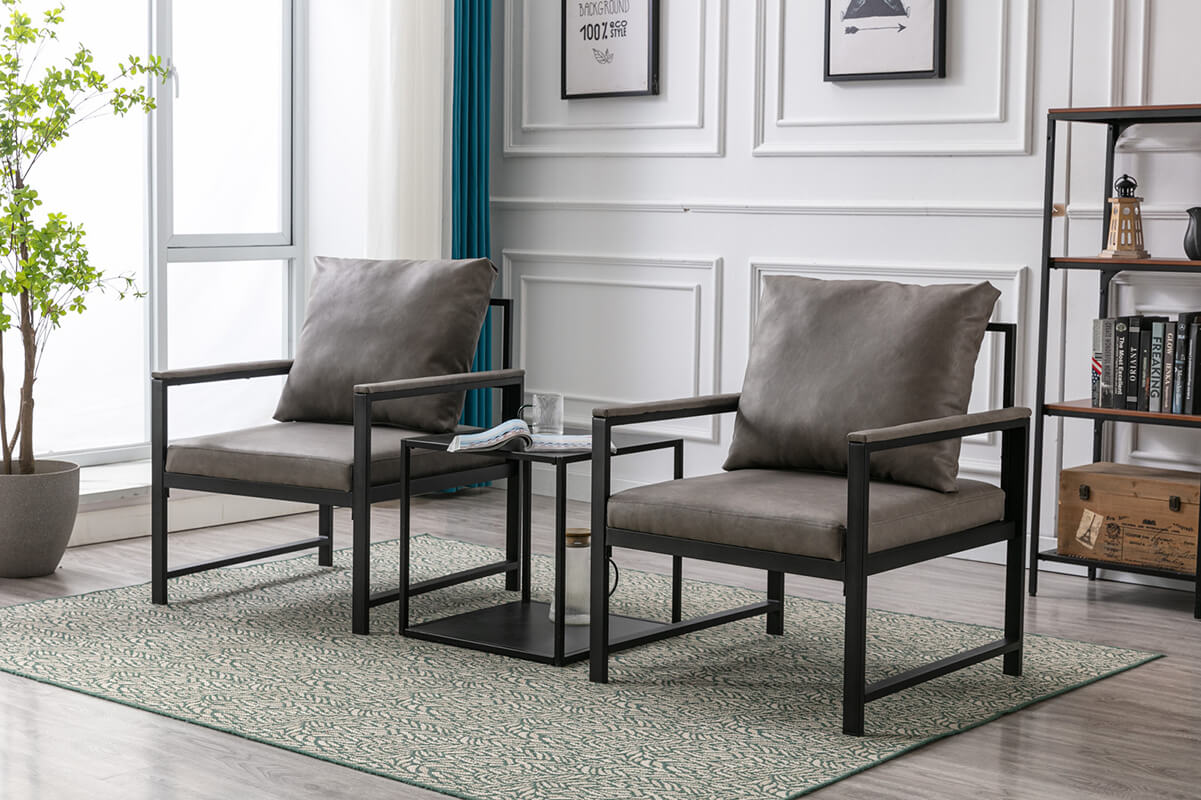 Side view of the sophisticated gray PU leather accent chair highlighting its padded back and black metal frame.