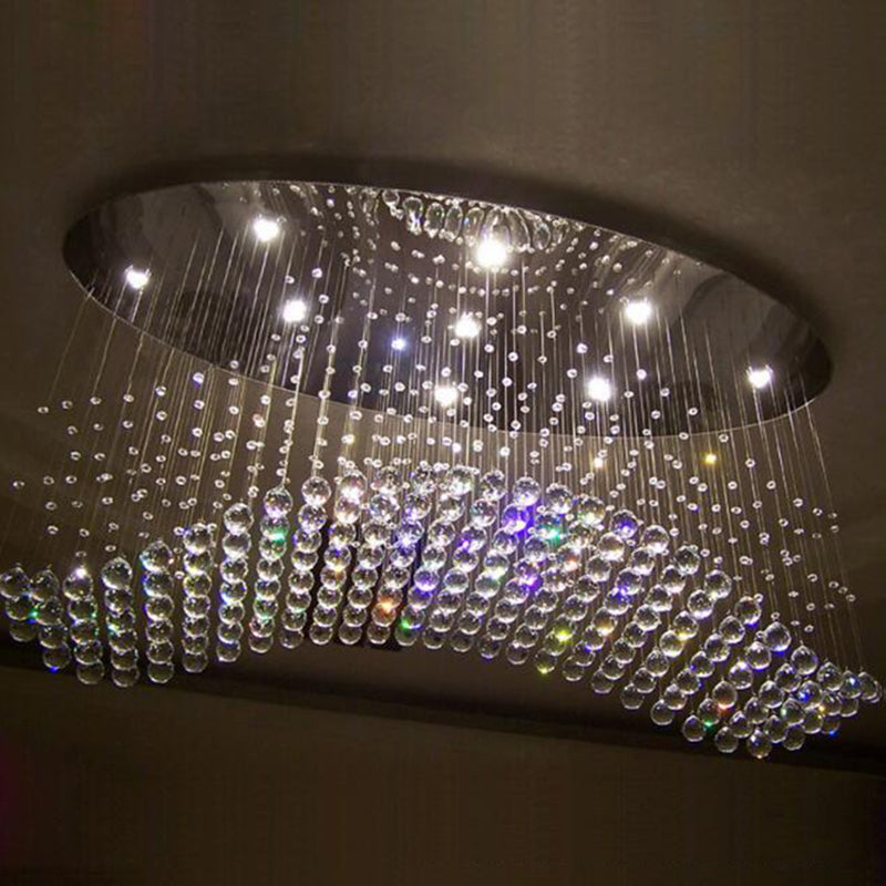 Elegant teardrop crystal flush mount light illuminating a cozy living room